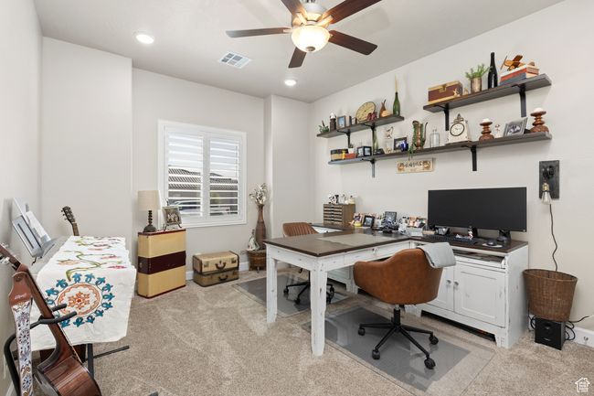 Home office with light colored carpet, a ceiling fan, and recessed lighting | Image 57