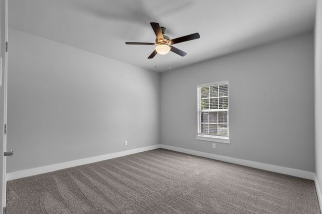 Carpeted spare room featuring a ceiling fan and baseboards | Image 19
