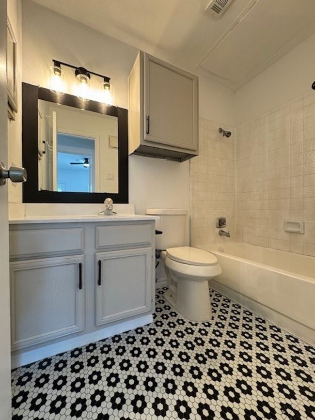 Full bath featuring vanity, shower / washtub combination, and tile patterned floors | Image 5