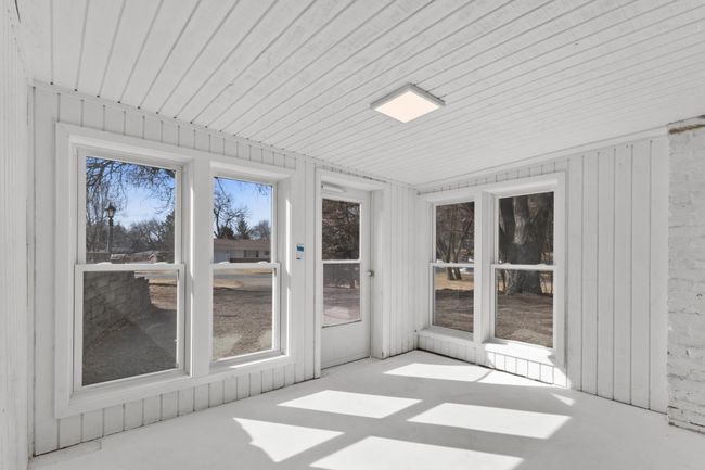 Porch in flooded with sunlight and is a separate entry to the lower level | Image 34