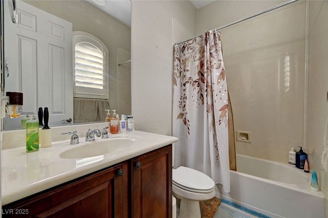 Bathroom with vanity, shower / bath combination with curtain, and tile patterned floors | Image 43