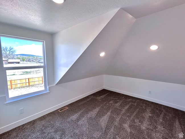 Additional living space with recessed lighting, visible vents, dark carpet, and baseboards | Image 24