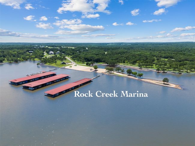 Aerial view of a heavily wooded area and a nearby body of water | Image 4