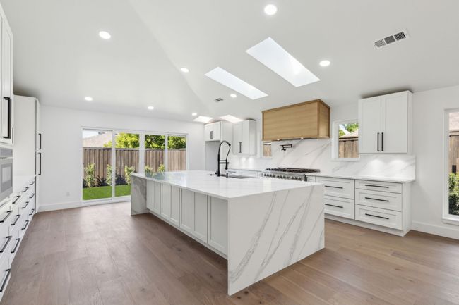 Skylight and slider doors offer beautiful natural lighting in this home | Image 10