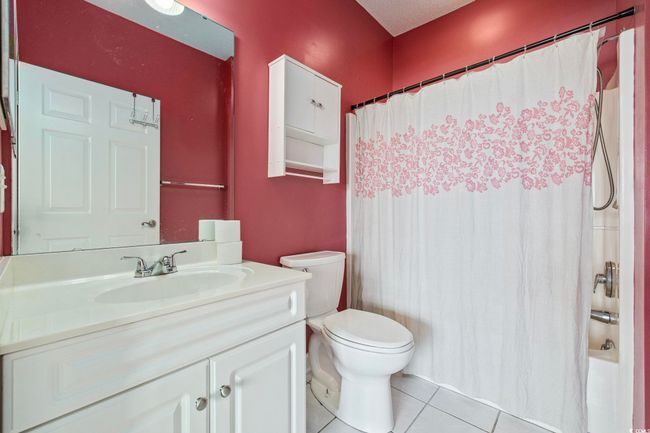 Full bathroom featuring vanity, tile patterned flooring, toilet, and shower / tub combo | Image 19