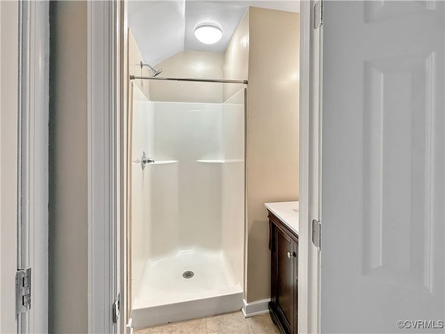 Bathroom featuring vanity, a shower, and lofted ceiling | Image 20