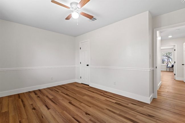 Empty room featuring a ceiling fan, light wood-style flooring, and baseboards | Image 17