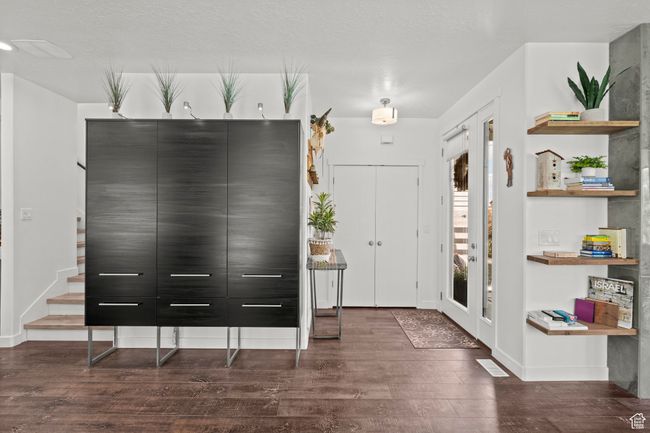 Foyer entrance with dark wood finished floors and baseboards | Image 5