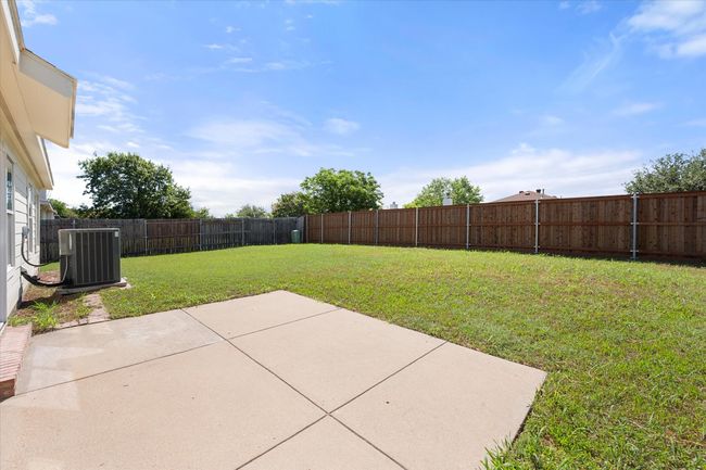 View of yard with cooling unit and a patio area | Image 24