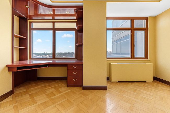 Unfurnished office with radiator heating unit and baseboards | Image 17