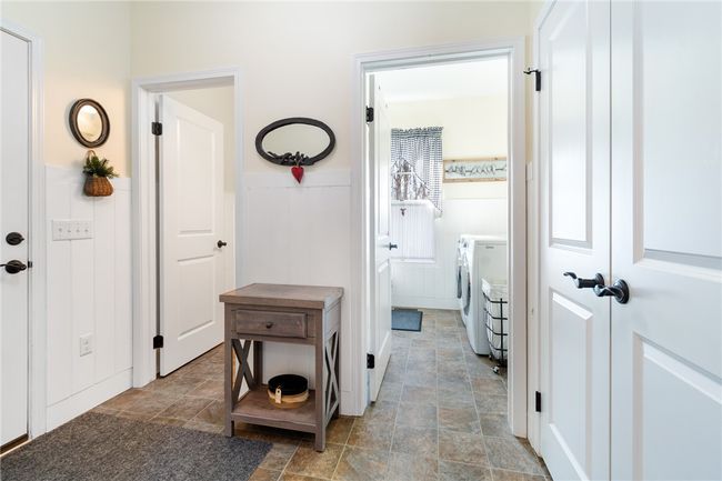 The half bath and laundry room - the large foyer is an open space to greet visitors- the entrance closet has a double door opening for lots of room! | Image 25