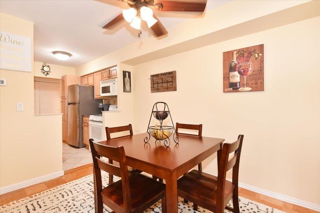 Dining area with a ceiling fan and light wood-type flooring | Image 14