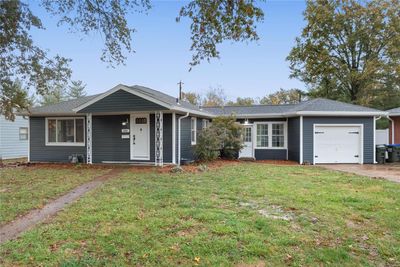 Single story home featuring a garage and a front yard | Image 1