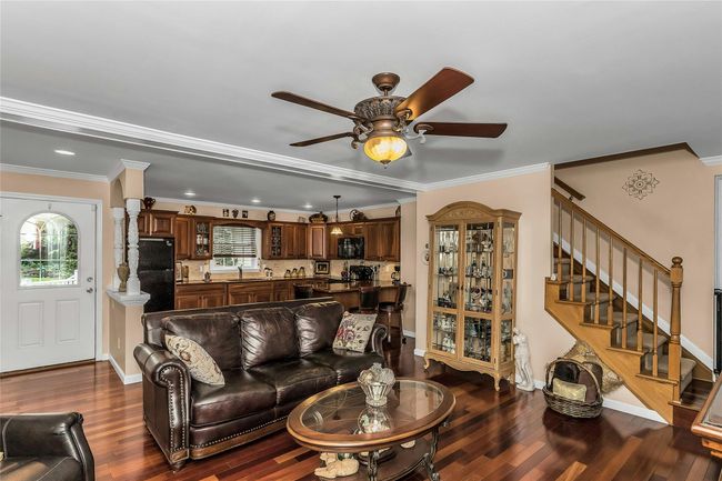 Living Room on Townhouse side with Stunning Hardwood Flooring | Image 24