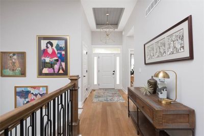 Entryway with a towering ceiling and light hardwood / wood-style flooring | Image 3