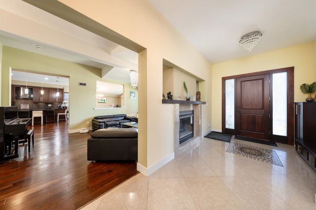 Foyer entrance featuring baseboards and a fireplace | Image 7