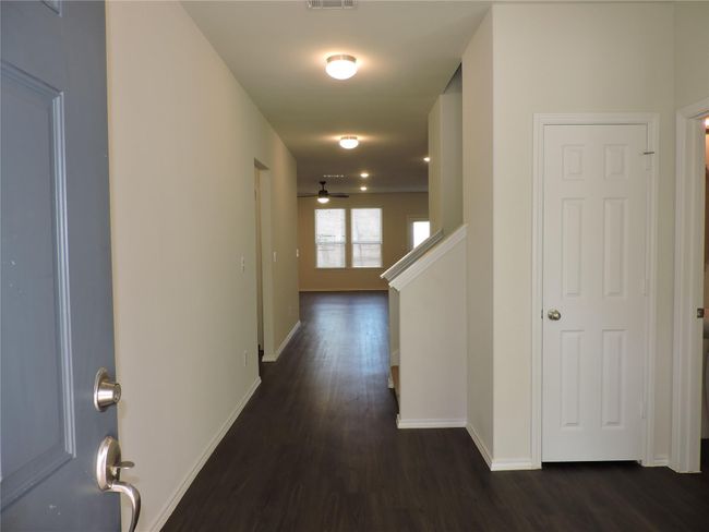 Upon entry your friends and family will be drawn to the open living spaces at the back of the home, to the immediate right is the Home Office, flex room, play room and also half bath, large storage closets in bath and hall. | Image 6