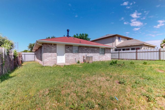 Back of property featuring a lawn, brick siding, and a fenced backyard | Image 34