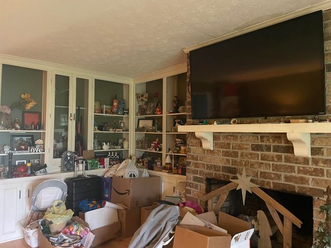 Misc room with ornamental molding, a brick fireplace, and a textured ceiling | Image 6