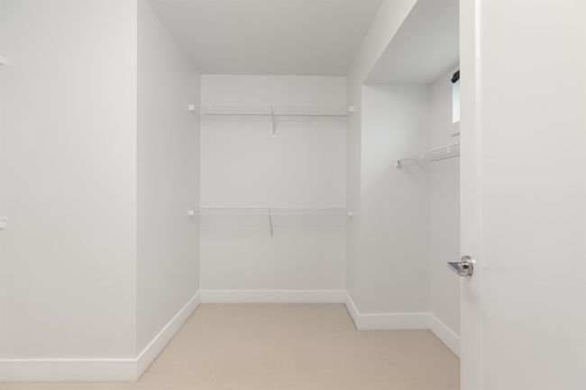 Spacious closet with light colored carpet | Image 18
