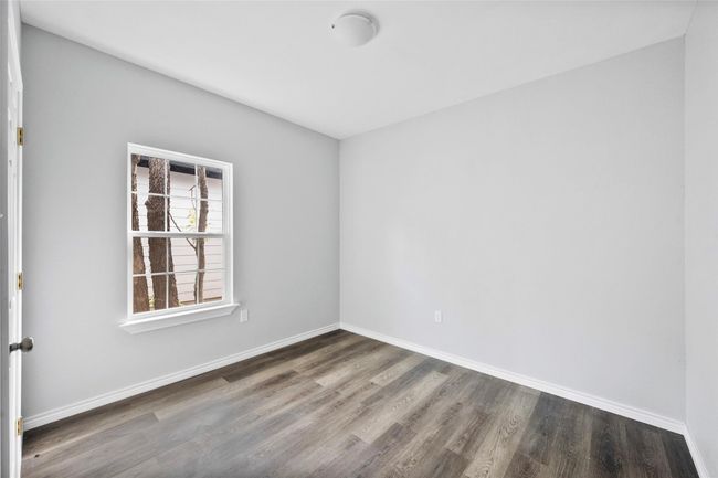 Spare room with wood finished floors and baseboards | Image 11