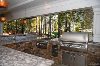 View of patio / terrace featuring sink, exterior kitchen, and area for grilling | Image 3