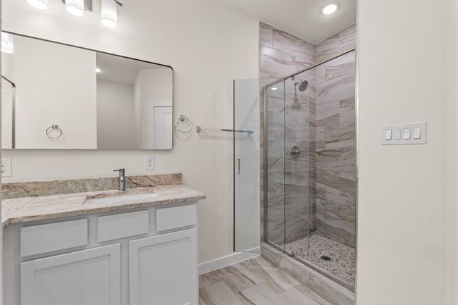 Full bath with vanity, a stall shower, baseboards, recessed lighting, and marble finish flooring | Image 24