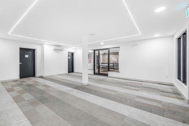 Unfurnished room with light carpet, a raised ceiling, an AC wall unit, recessed lighting, and baseboards | Image 31