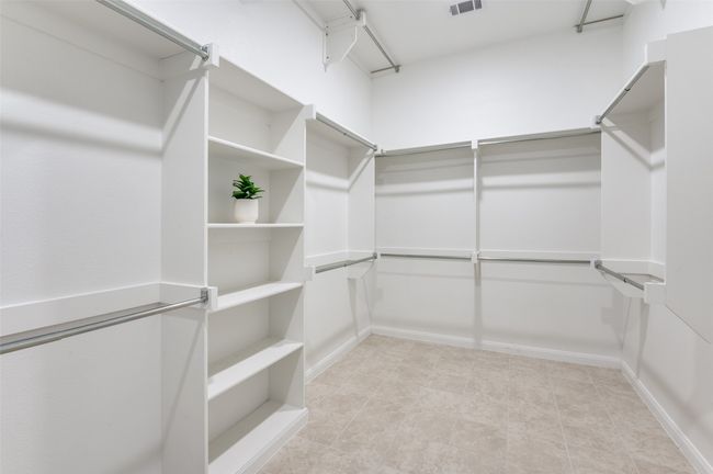 Expansive walk-in closet featuring ample storage space, built-in shelving, and strategically placed air vents for optimal airflow and ventilation. | Image 20