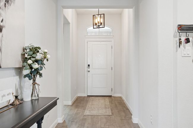 Entrance foyer with a chandelier and light wood finished floors | Image 4