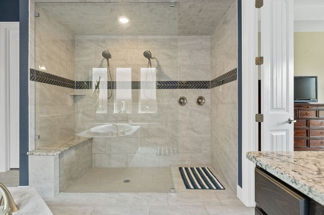 Bathroom with a tile shower and vanity | Image 25