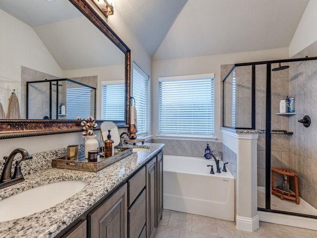 Bathroom featuring lofted ceiling, vanity, tile patterned floors, and shower with separate bathtub | Image 22
