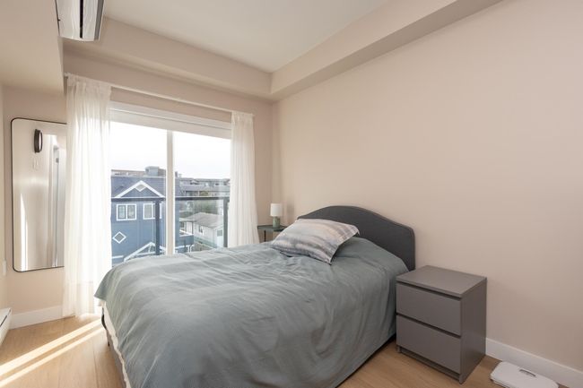Bedroom featuring access to outside, light wood-style flooring, and baseboards | Image 14