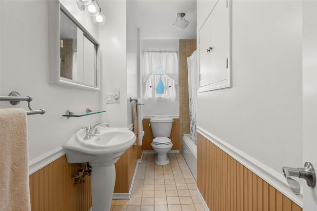 First Floor Hall bath with tile patterned floors, toilet, and shower / tub combo | Image 15