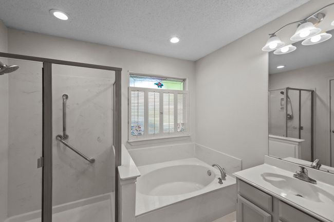Bathroom with a separate shower, dual vanity, garden tub, and recessed lighting | Image 26