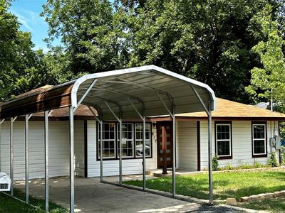 NEW CARPORT!! View of front of property featuring a carport and a front lawn | Image 2