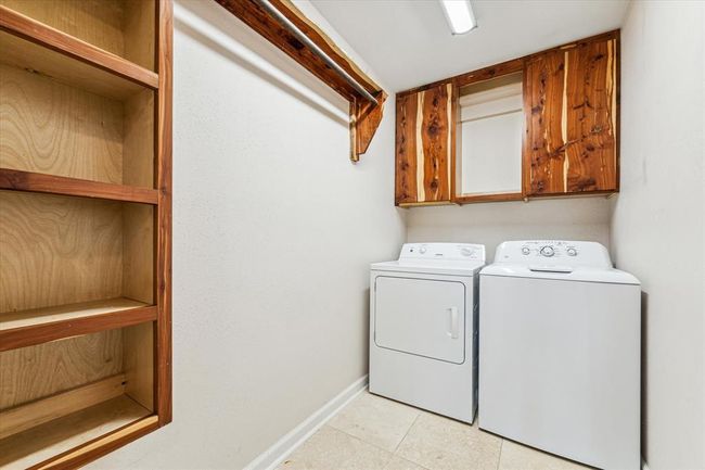 Spacious laundry room with beautiful cedar cabinetry and built-in storage | Image 32