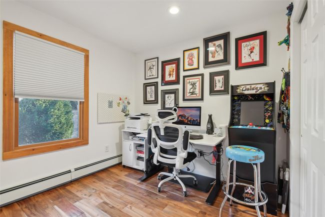 Office space with baseboard heating and wood finished floors | Image 23