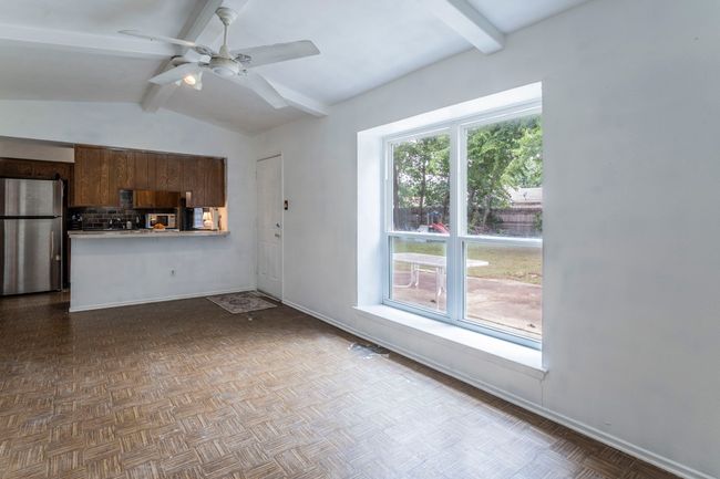 Large window facing the spacious wooded back yard. | Image 11