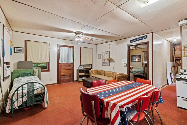 Dining room featuring a ceiling fan and carpet floors | Image 25