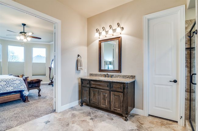 The grand ensuite primary bath features double, granite topped vanities. | Image 21