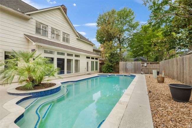 The pool and spa stretch across the width of the backyard, creating a tranquil outdoor escape perfect for both relaxation and entertaining. Updated in 2020 with a new pool pump added in 2024, this outdoor space is ready for years of enjoyment. | Image 36