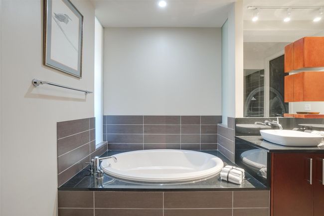Bathroom featuring a garden tub, double vanity, and track lighting | Image 34