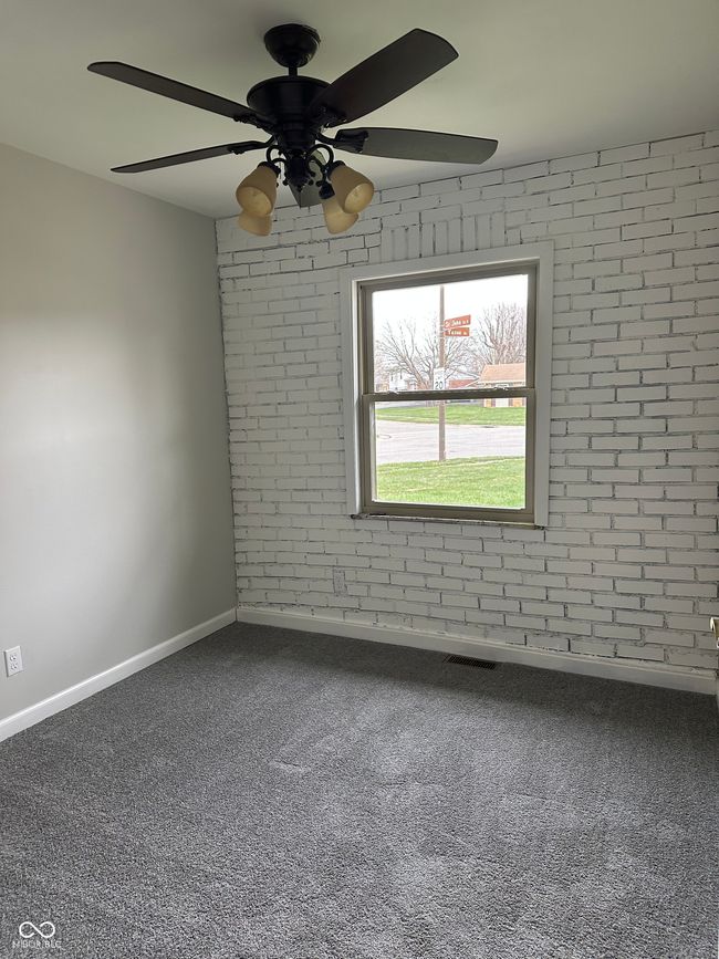 Bedroom with unique brick wall. | Image 4