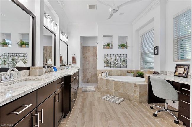 Bathroom featuring visible vents, wood tiled floor, ornamental molding, a walk in shower, and a garden tub | Image 47