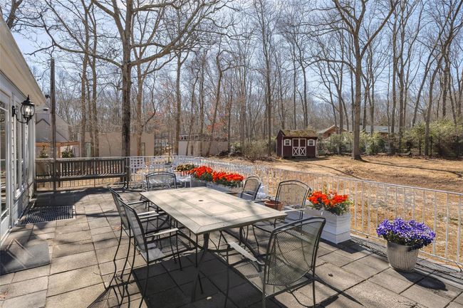 View of patio / terrace featuring outdoor dining space, an outbuilding, and a shed | Image 32