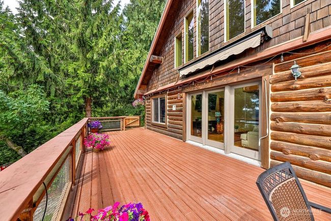 Huge wrap-around trex deck perfect for entertaining and relaxing with a water view! | Image 25