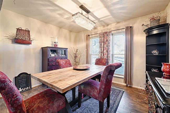 Dining room featuring plenty of natural light, dark hardwood / wood-style flooring, and an inviting chandelier | Image 20