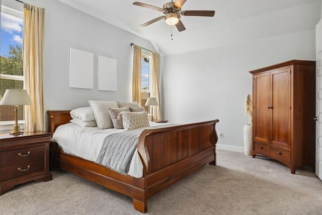 Bedroom featuring lofted ceiling, light carpet, and a ceiling fan | Image 20