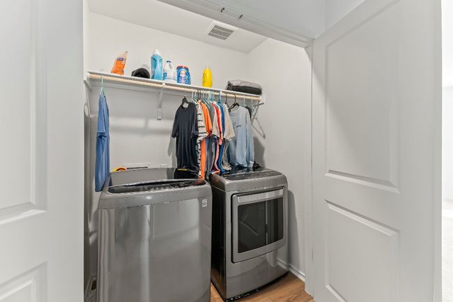 Laundry room featuring washer and dryer and light wood-style flooring | Image 26